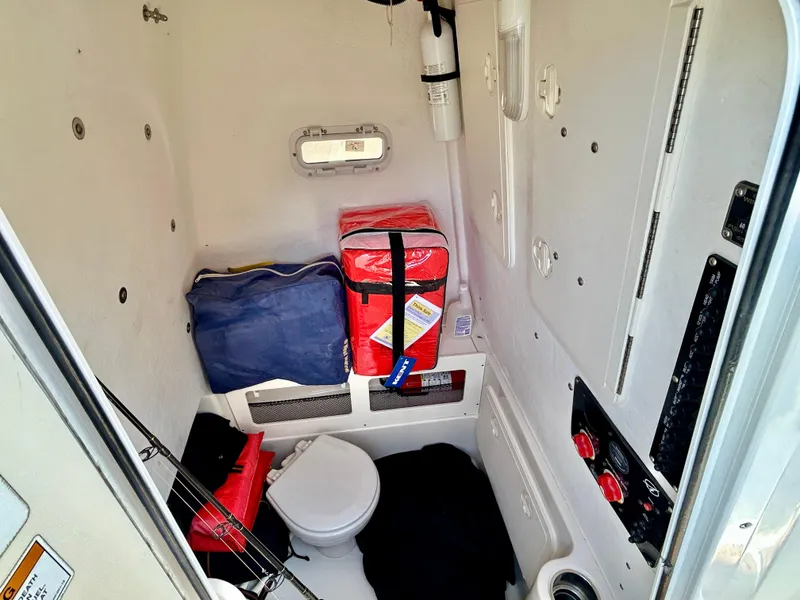 Slide: The Image of Interior of a 2013 Sailfish 270 CC boat cabin with storage and equipment. - 32