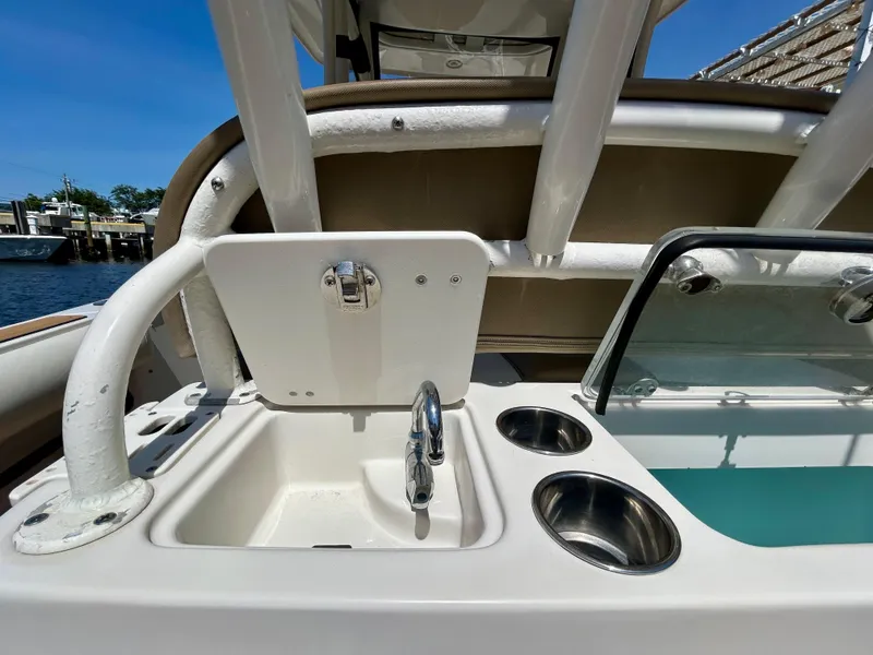 Slide: The Image of 2013 Sailfish 270 CC boat sink and cup holders on deck. - 36