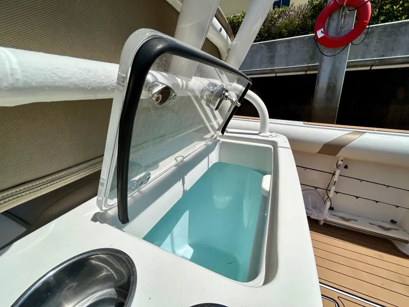 Slide: The Image of 2013 Sailfish 270 CC boat with open livewell and cup holder on deck. - 37
