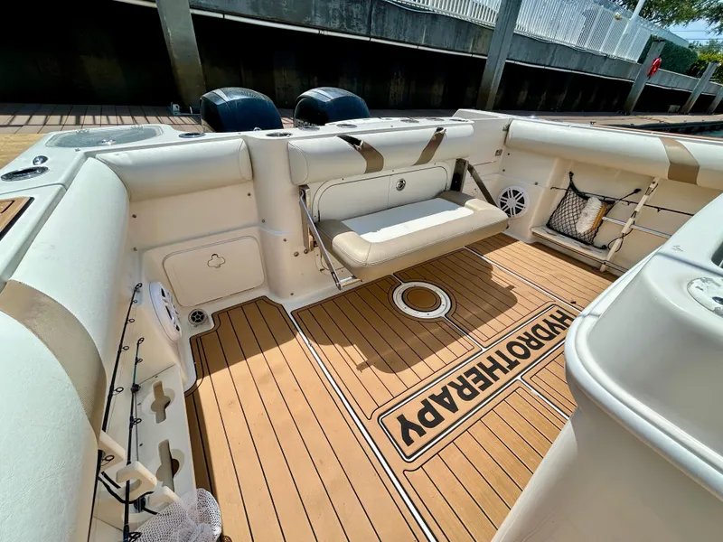 Slide: The Image of 2013 Sailfish 270 CC boat interior with cushioned seating and teak flooring. - 39