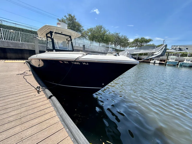 Slide: The Image of 2013 Sailfish 270 CC boat docked on a sunny day. - 4