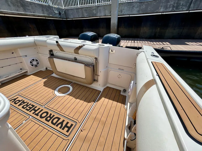 Slide: The Image of 2013 Sailfish 270 CC boat deck with Hydrotherapy flooring, docked at marina. - 40