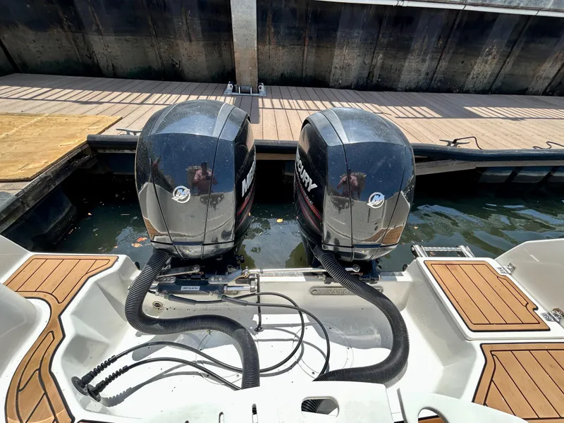 Slide: The Image of Twin Mercury outboard engines on a 2013 Sailfish 270 CC boat at a dock. - 44