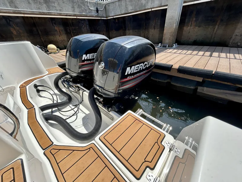 Slide: The Image of Twin Mercury outboard engines on a 2013 Sailfish 270 CC boat at dock. - 46