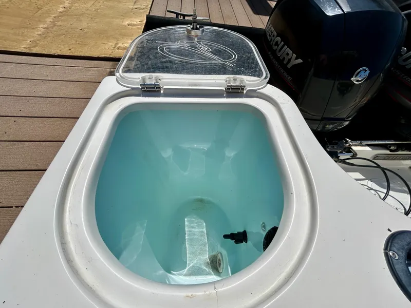 Slide: The Image of Livewell on a 2013 Sailfish 270 CC boat with Mercury engine in background. - 49