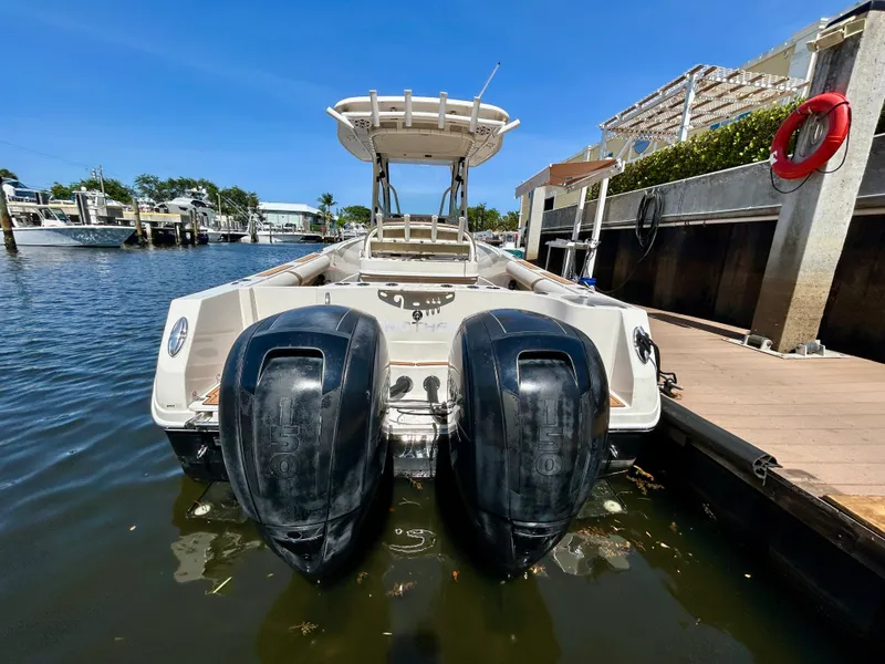 Slide: The Image of 2013 Sailfish 270 CC boat with dual outboard motors docked in a marina. - 6