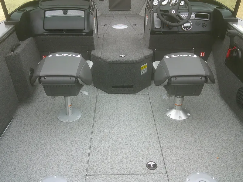 Slide: The Image of 2025 Lund 2075 Fisherman boat interior with two seats and steering console. - 13