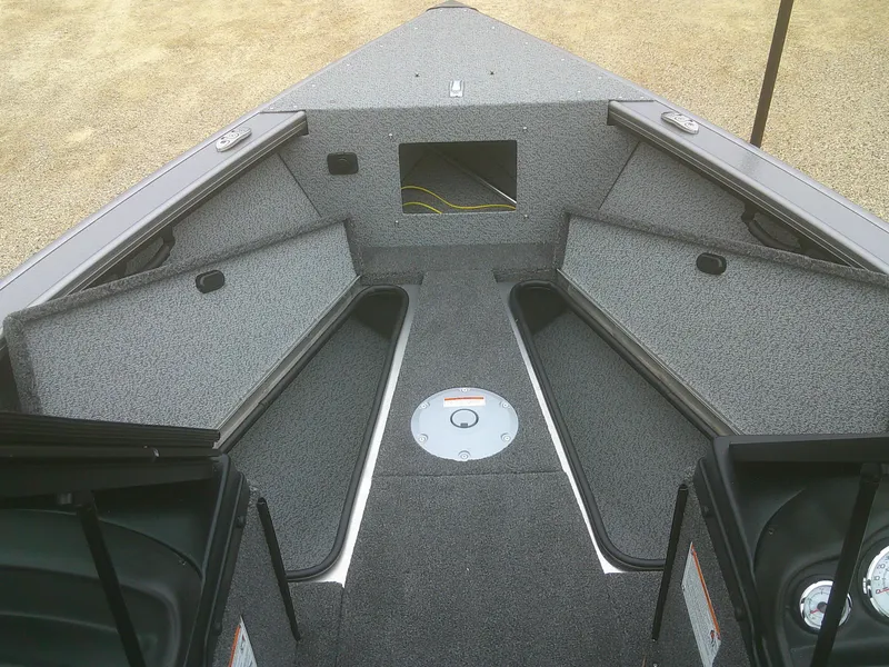 Slide: The Image of 2025 Lund 2075 Fisherman boat interior with storage compartments and carpeted deck. - 6