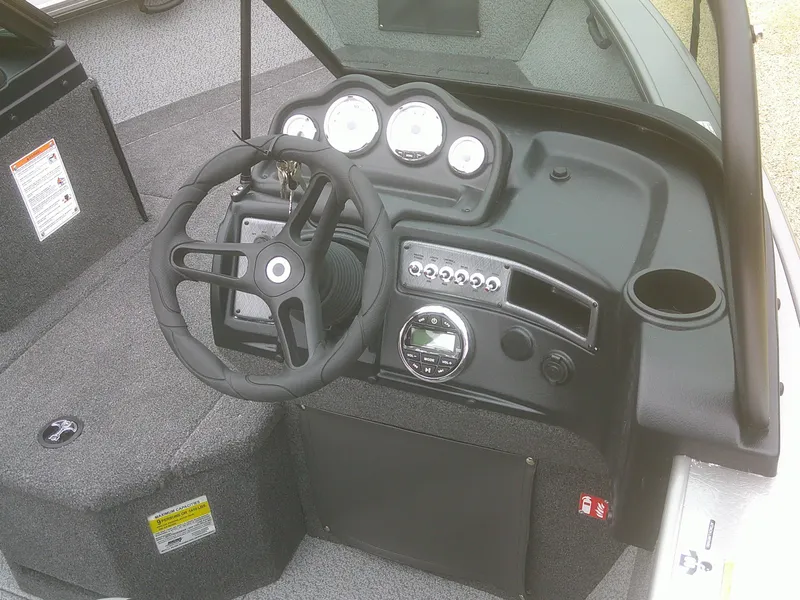 Slide: The Image of 2025 Lund 2075 Fisherman boat dashboard with steering wheel and instrument panel. - 9