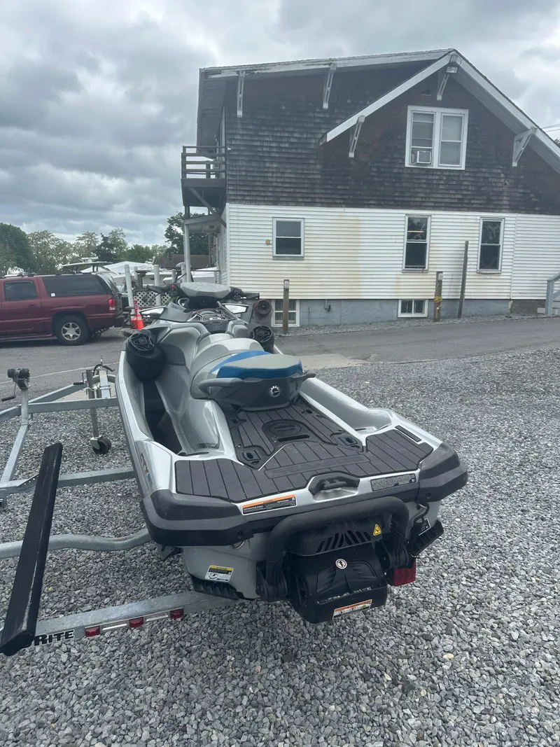 The Image of 2020 Sea-Doo GTX Limited 300 on trailer, parked near a house. - 1