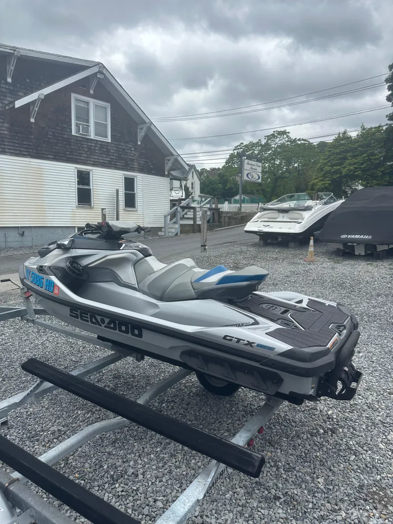 Slide: The Image of 2020 Sea-Doo GTX Limited 300 jet ski on trailer, parked outdoors. - 8