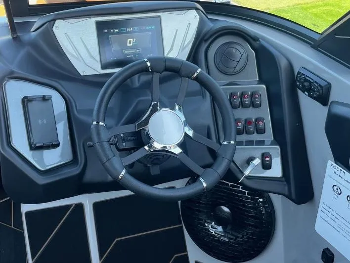 Slide: The Image of Steering wheel and dashboard of 2025 Supreme S240 boat with modern controls and display. - 13