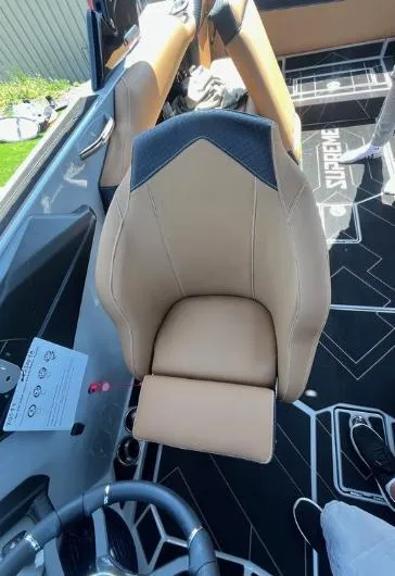 Slide: The Image of 2025 Supreme S240 boat interior with tan leather seat and branded flooring. - 21