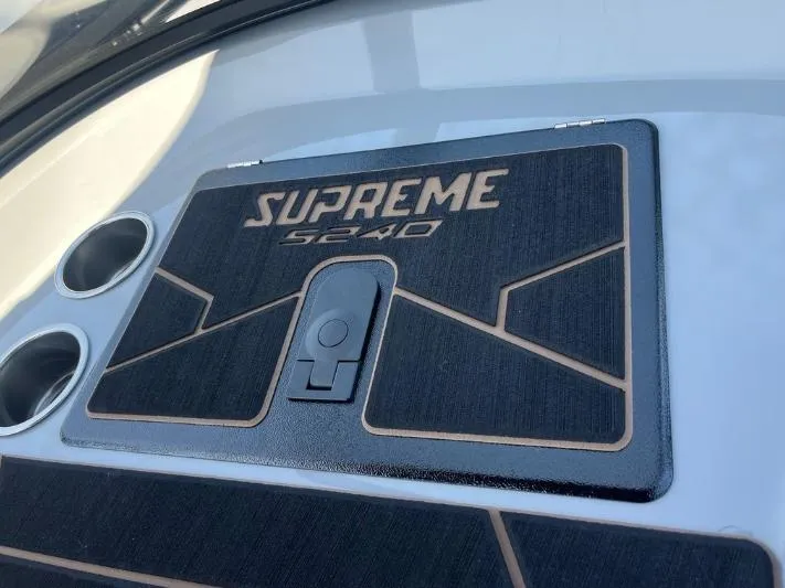 Slide: The Image of 2025 Supreme S240 boat dashboard with cup holders and sleek design. - 24