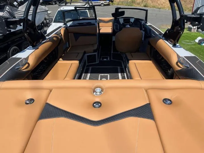 Slide: The Image of 2025 Supreme S240 boat interior with tan leather seating and modern design. - 3