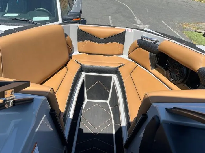 Slide: The Image of Luxurious interior of 2025 Supreme S240 boat with tan and black seating. - 32