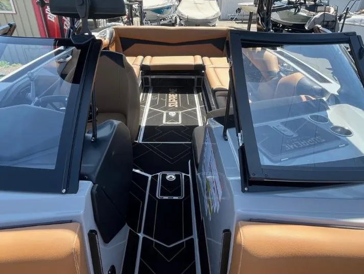 Slide: The Image of 2025 Supreme S240 boat interior with tan seats and black flooring. - 37