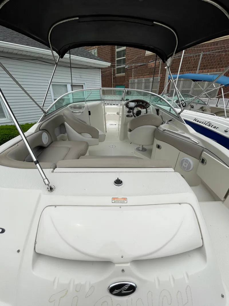Slide: The Image of 2004 Sea Ray 220 Sundeck boat with spacious seating and canopy. - 10