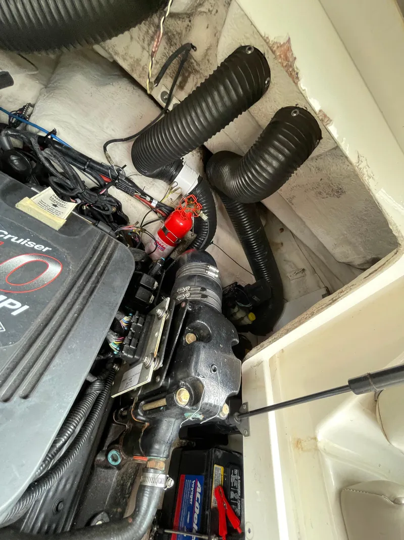 Slide: The Image of Engine compartment of a 2004 Sea Ray 220 Sundeck with visible components and wiring. - 12