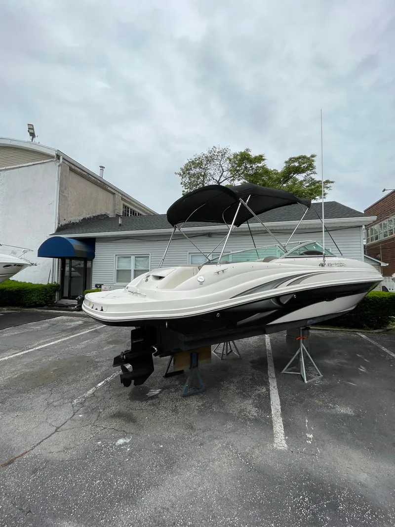 Slide: The Image of 2004 Sea Ray 220 Sundeck boat on stands in a parking lot. - 17