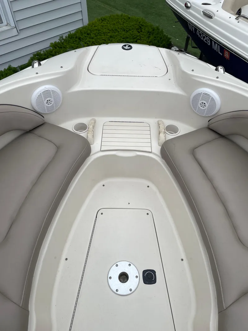 Slide: The Image of 2004 Sea Ray 220 Sundeck boat interior with seating and speakers. - 27