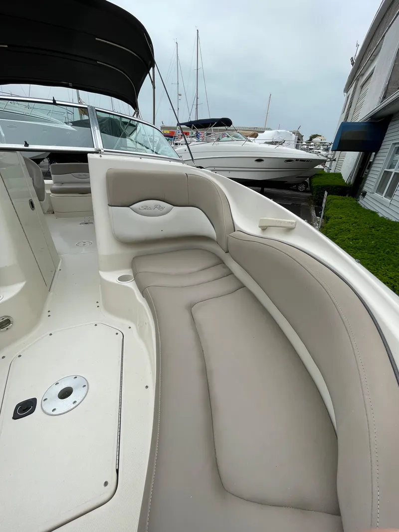 Slide: The Image of 2004 Sea Ray 220 Sundeck with spacious seating and sleek design. - 6