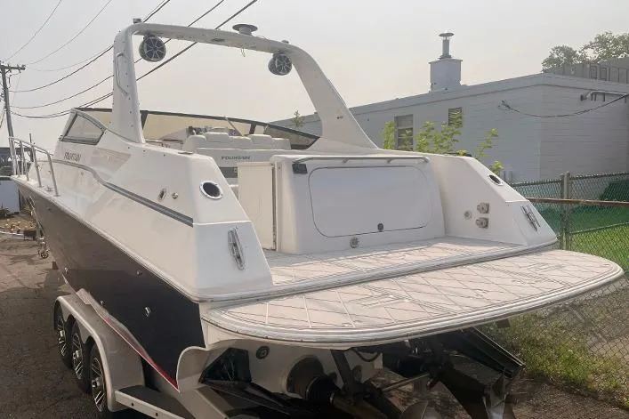 Slide: The Image of 2002 Fountain 38 Express Cruiser boat on trailer, rear view, in outdoor setting. - 1