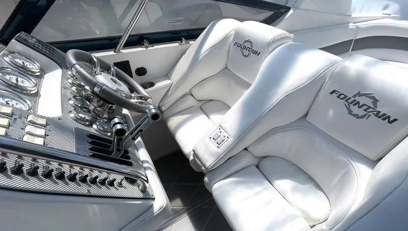 Slide: The Image of 2002 Fountain 38 Express Cruiser cockpit with white leather seats and sleek control panel. - 5