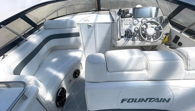 Slide: The Image of 2002 Fountain 38 Express Cruiser cockpit with white seating and modern control panel. - 6