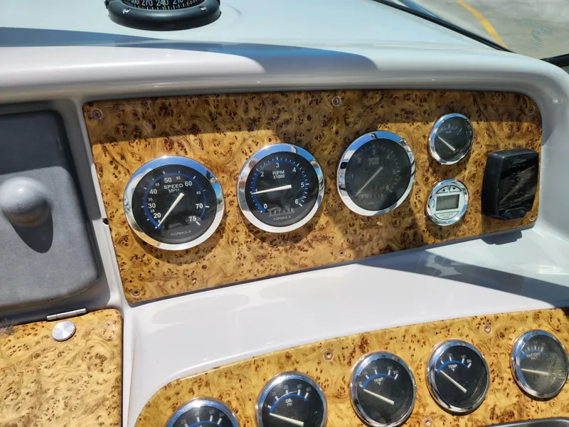 Slide: The Image of Dashboard of a 2007 Formula 330 Sun Sport boat with wood paneling and gauges. - 11