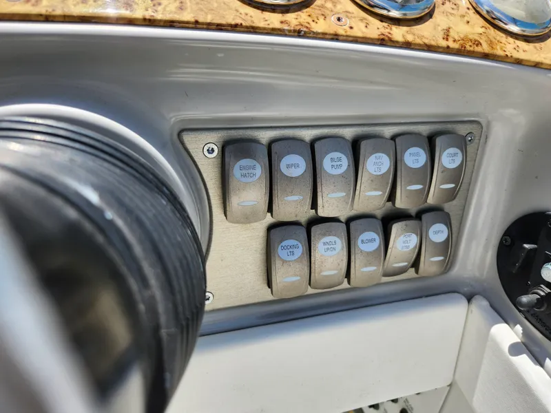 Slide: The Image of Control panel of a 2007 Formula 330 Sun Sport boat with labeled switches. - 12