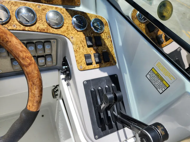 Slide: The Image of 2007 Formula 330 Sun Sport dashboard with wood accents and control levers. - 13