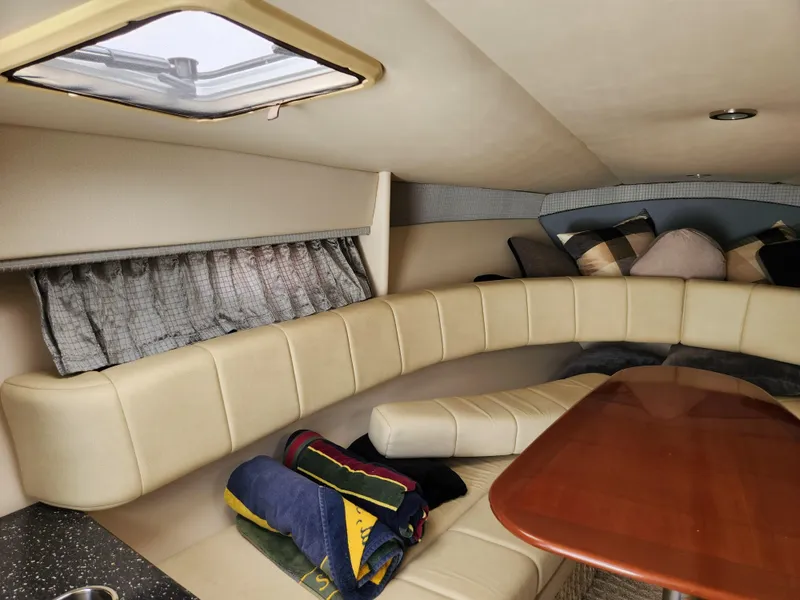 Slide: The Image of 2007 Formula 330 Sun Sport cabin interior with beige seating and wooden table. - 22