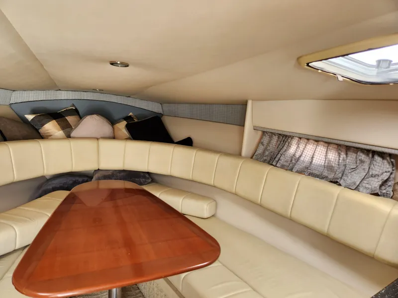 Slide: The Image of Interior of 2007 Formula 330 Sun Sport boat with beige seating and wooden table. - 23