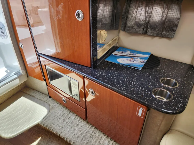 Slide: The Image of 2007 Formula 330 Sun Sport interior with wood cabinetry, microwave, and countertop. - 25
