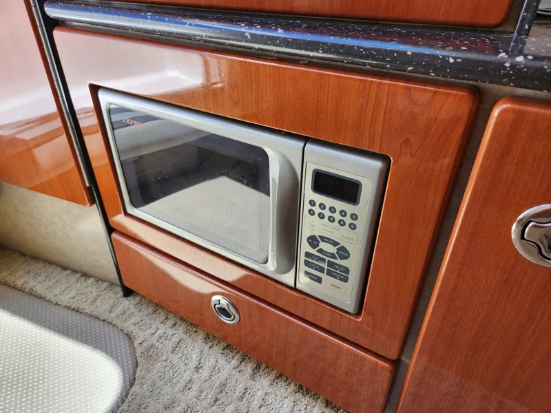Slide: The Image of Built-in microwave in 2007 Formula 330 Sun Sport boat kitchen area. - 26