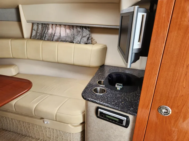 Slide: The Image of Interior of 2007 Formula 330 Sun Sport boat with seating, TV, and counter space. - 29