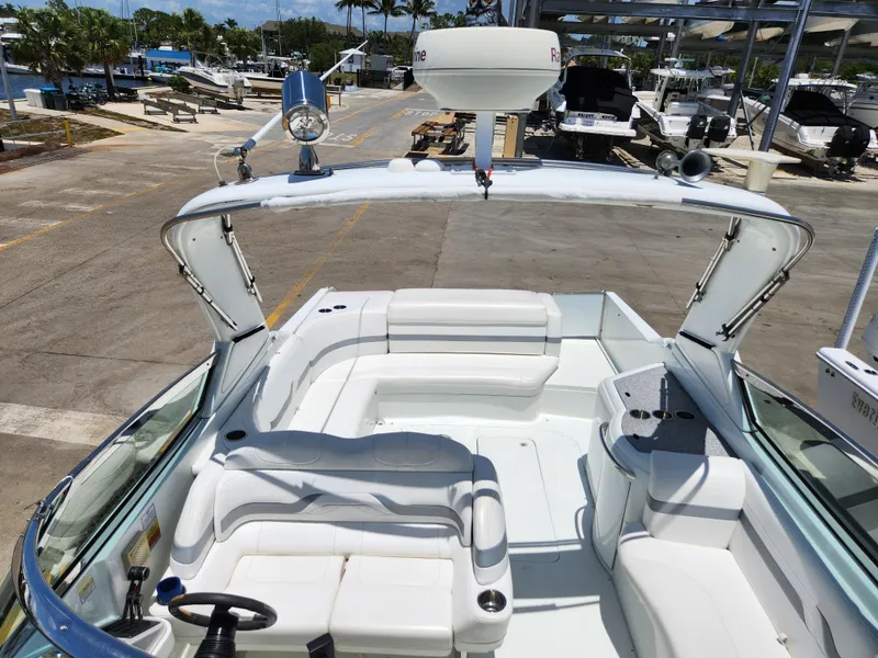 Slide: The Image of 2007 Formula 330 Sun Sport boat with spacious white seating and modern amenities at a marina. - 36