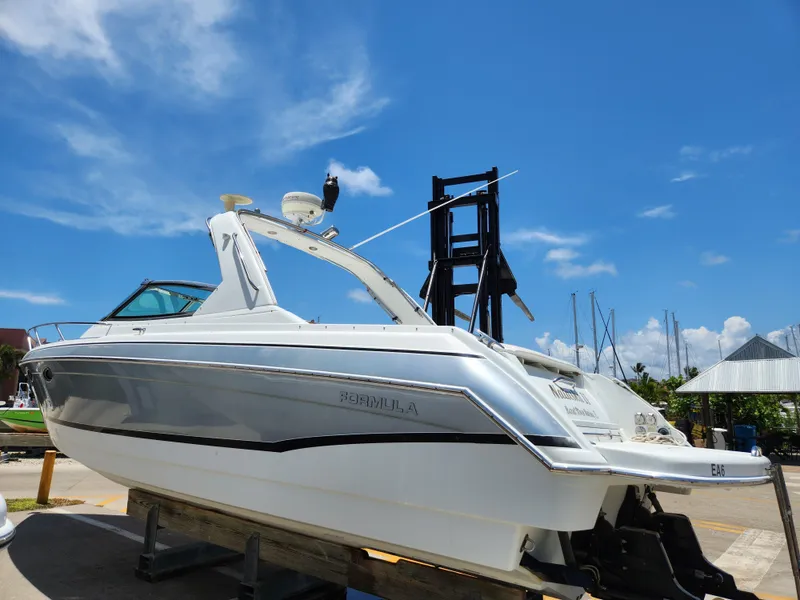 Slide: The Image of 2007 Formula 330 Sun Sport boat on a lift under a clear blue sky. - 4