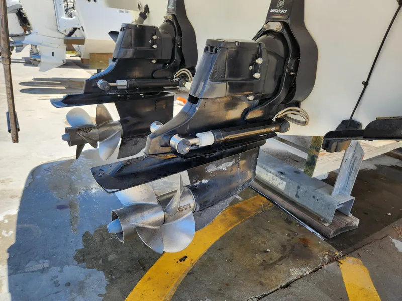 Slide: The Image of 2007 Formula 330 Sun Sport boat propellers and outdrives in a marina setting. - 40