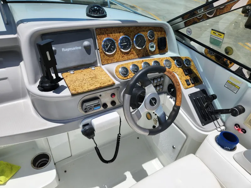 Slide: The Image of 2007 Formula 330 Sun Sport dashboard with steering wheel, gauges, and navigation equipment. - 9