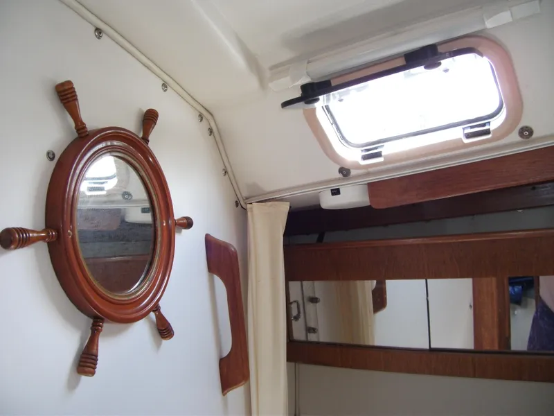 Slide: The Image of Interior of 1992 Catalina 30 MkII sailboat with porthole and wooden accents. - 12