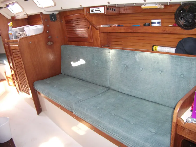 Slide: The Image of Interior of a 1992 Catalina 30 MkII sailboat with blue cushioned seating. - 14
