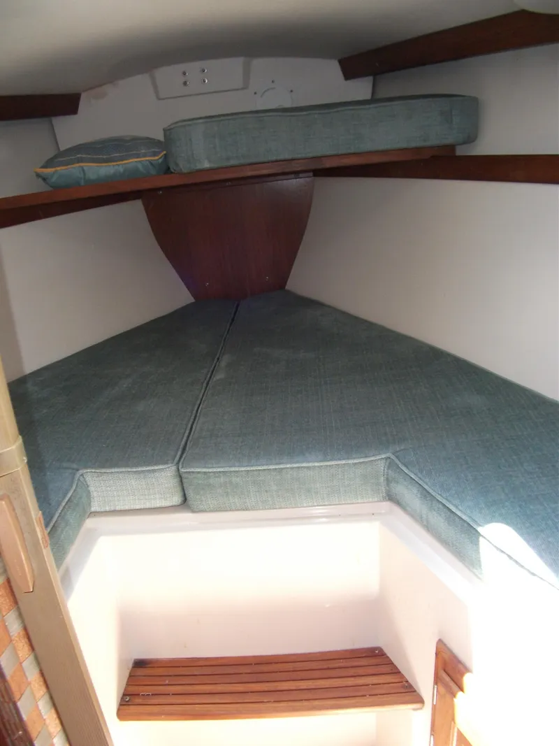 Slide: The Image of 1992 Catalina 30 MkII interior cabin with cushioned V-berth and wooden accents. - 15
