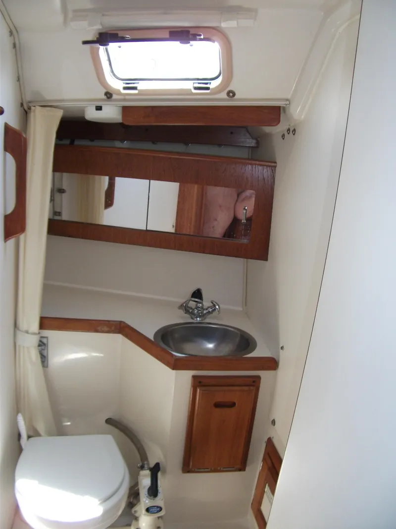 Slide: The Image of 1992 Catalina 30 MkII yacht bathroom with sink, toilet, and wooden cabinetry. - 19