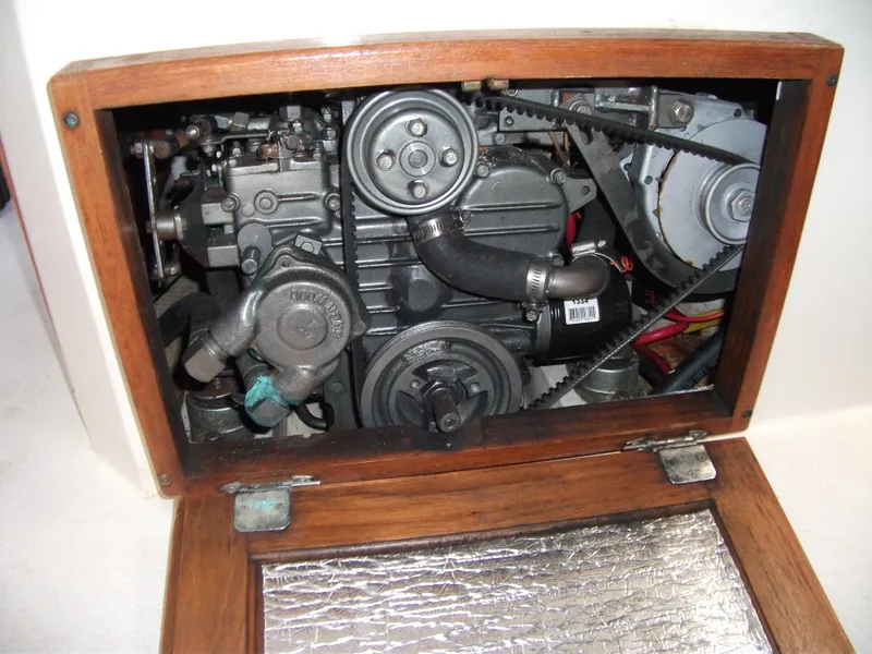 Slide: The Image of Engine compartment of a 1992 Catalina 30 MkII sailboat, showcasing mechanical components. - 22