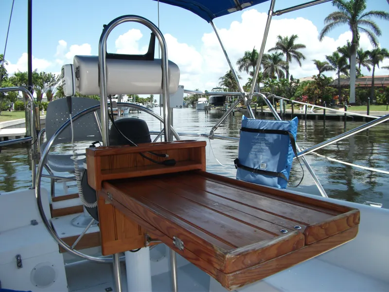 Slide: The Image of Cockpit of 1992 Catalina 30 MkII sailboat with wooden table and marina view. - 27