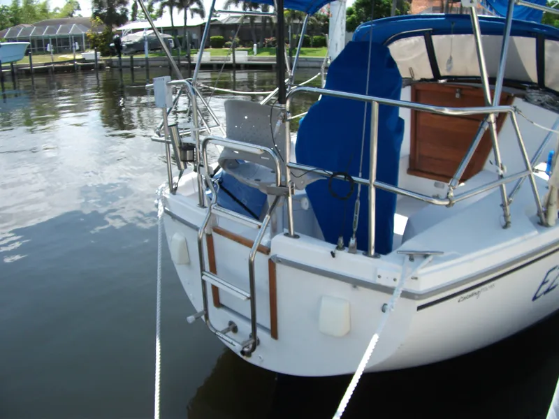 Slide: The Image of Catalina 30 MkII 1992 sailboat docked, featuring a blue canopy and stainless steel railings. - 4