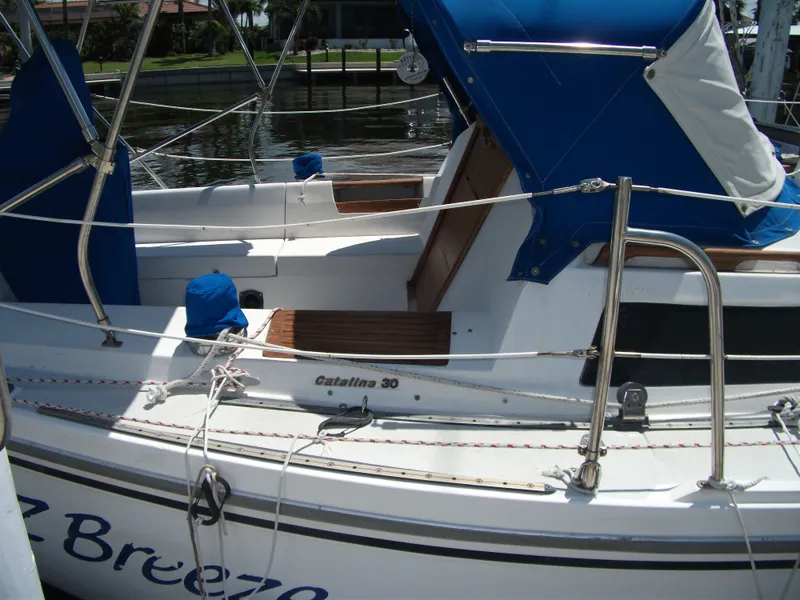 Slide: The Image of 1992 Catalina 30 MkII sailboat with blue canopy, docked at marina. - 5
