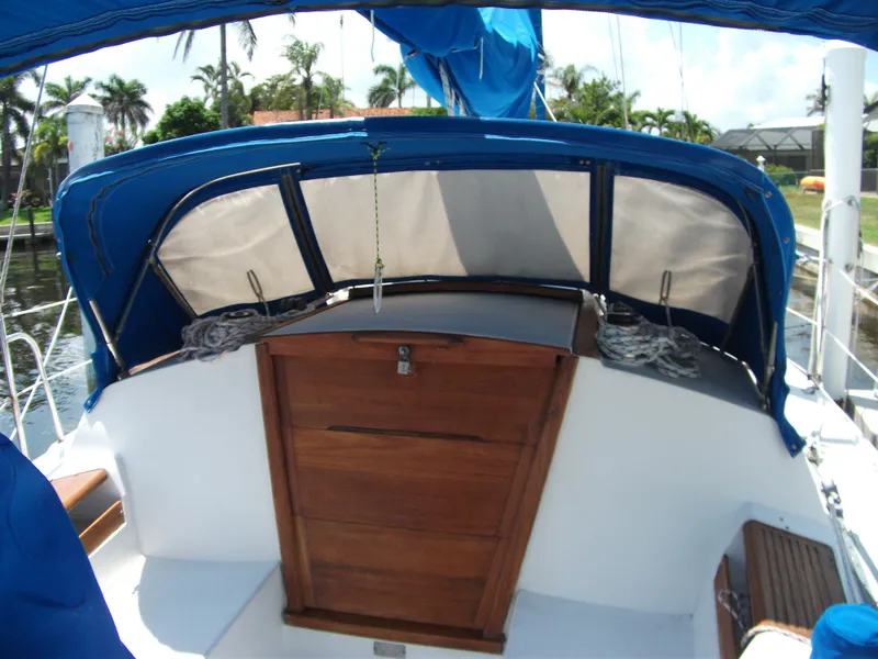 Slide: The Image of 1992 Catalina 30 MkII sailboat cockpit with blue canopy and wooden hatch. - 6